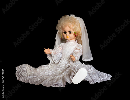 Miniature toy doll on a black background.