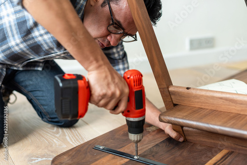 Canvas Print Man assembling wooden furniture photo