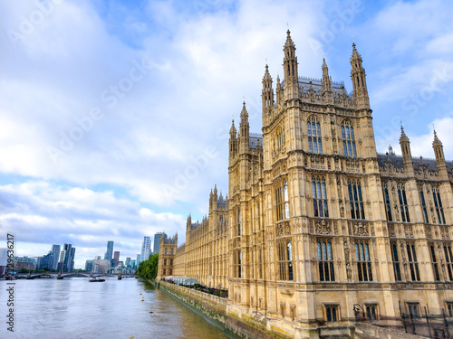 view of the Big Ben clock tower, Elizabeth Tower, and Houses of Parliament reflected on the River Thames in London, United Kingdom