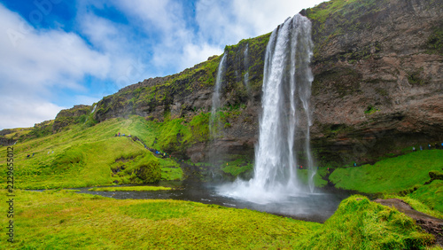 Seljalandsfoss waterfall in Iceland during summer with lush green landscape and mist