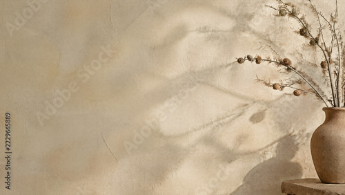 Festive Wabi-Sabi background with rustic clay vase, bare larch branches and zen plaster wall