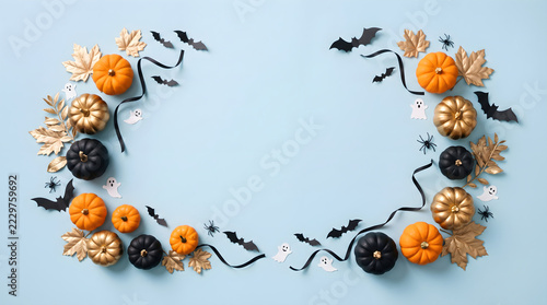 Flat lay Halloween background with decorative pumpkins bats leaves and spiders
