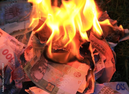 Burning Ukrainian money. Inflation that is eroding and devaluing Ukrainian money (currency). The fire and blaze devouring the Ukrainian hryvnia. A bonfire made of paper money. Finances devaluation