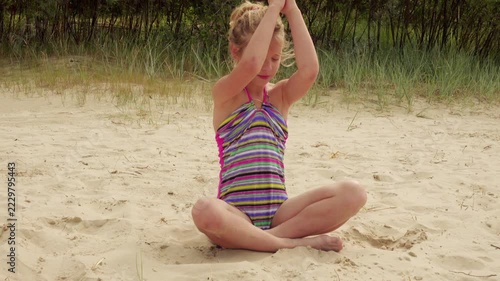 Little girl walks on sandy beach, Jurmala, Latvia