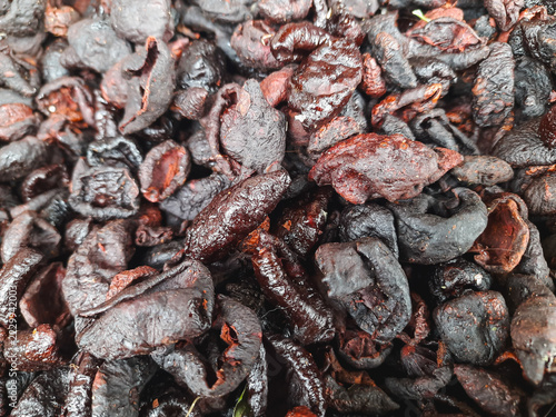 kandis acid or dried mangosteen rind piled close together. Texture is rough and wrinkled, rich and deep hues. Traditional indonesian spice, commonly used as a souring food in Minangkabau cuisine