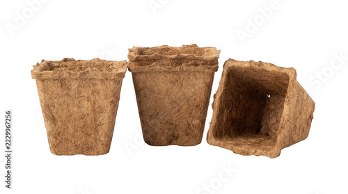 Three square biodegradable peat pots for seedlings on black background