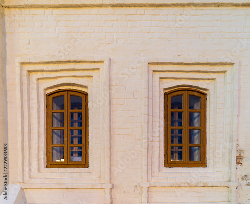 Windows of an old white-stone building in Russian style on the territory of the Kazan Kremlin. Russia