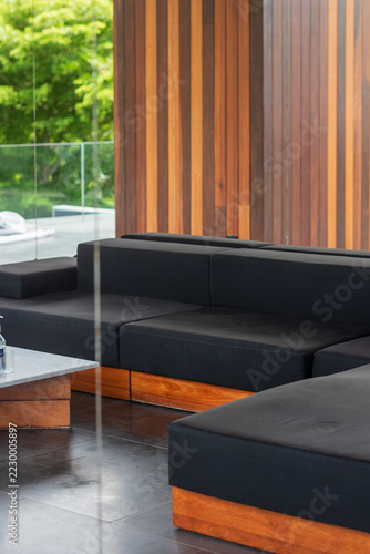 Modular luxury sofa with wooden slat architectural background in hospitality lounge seating staging