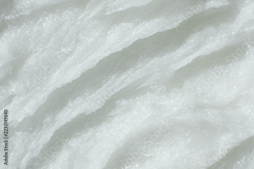 Detailed top view of unrefined solid coconut fat texture