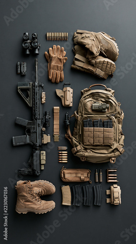Military clothing: backpack, boots, weapon. Against a solid-color background 