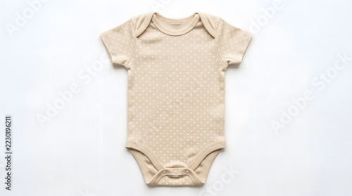 Beige polka dot baby onesie bodysuit photographed flat on a white background, showing short sleeves, snap closures and soft cotton texture ideal for newborns, gender-neutral wardrobes, gifts and produ