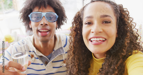 Image of happy diverse couple celebrating new years eve and making image call