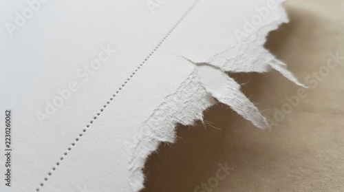 Beige paper with rough torn edge