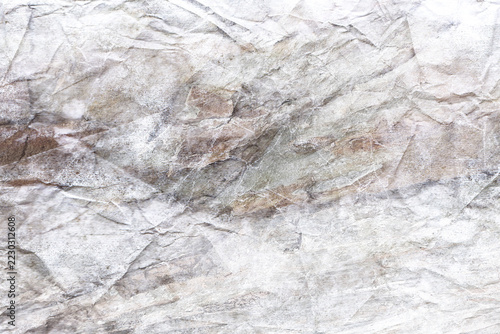 Texture background of a worn, crumpled paper surface; beige grunge background.