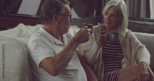 Senior Caucasian couple enjoys a cozy coffee break at home