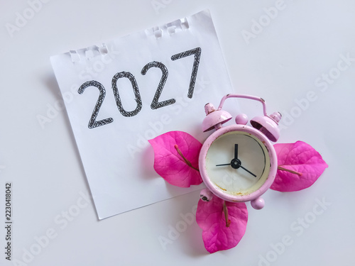 Clock and calendar. Close up of 2027 text on calendar with clock. 2027 target plan concept