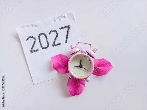 Close up of 2027 text on calendar with clock. 2027 target plan concept
