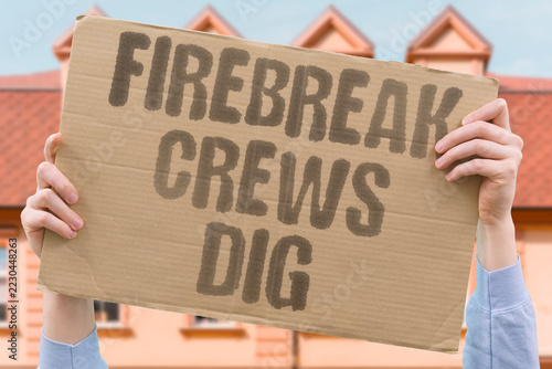 Obraz na plátně "Firebreak crews dig" Workers carve barriers to stop flames