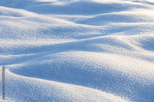 Fresh powder snow with soft blue shadow waves