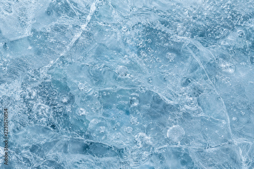 Pale cyan ice surface with organic trapped air bubbles