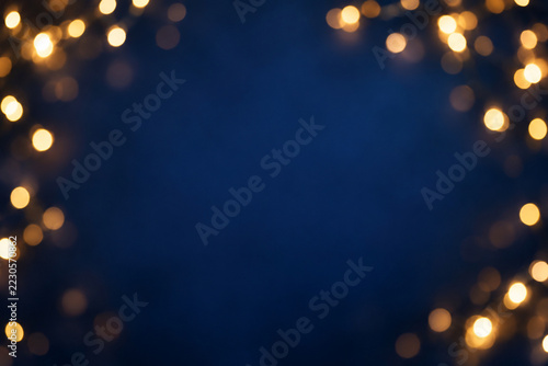 Warm golden light bokeh on a deep navy background