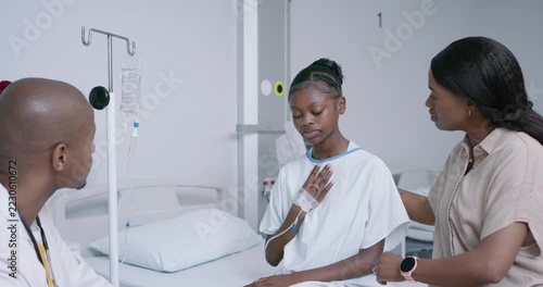 Youth patient with mother and clinician reporting chest pain for exam at bedside, mother holding IV