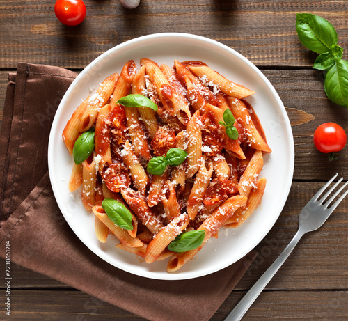 Italian penne pasta with tomato bolognese sauce on plate