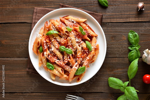 Italian penne pasta with tomato bolognese sauce on plate