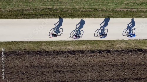 Cyclists, bicycles, shadows, riding on a path, Subotica, Serbia. g2.