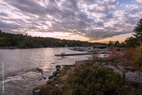 Stunning sunset view over Killarney Channel in Ontario, showcasing calm waters, rocky shores, and a vibrant sky.