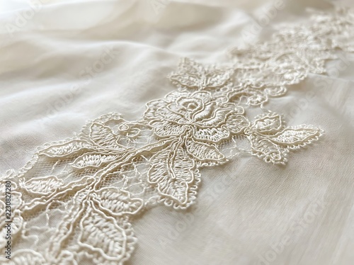 Close up of vintage cream lace collar with floral embroidery
