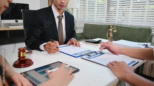 Business and lawyers discussing contract papers with brass scale on desk in office. Law, legal services, advice, justice and law concept .