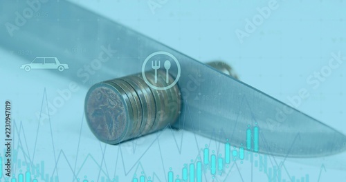 Balancing tarnished coin stack under stainless-steel knife blade on tabletop, financial overlays