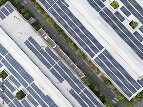 Obraz na plátně Aerial view of solar panels on industrial rooftops