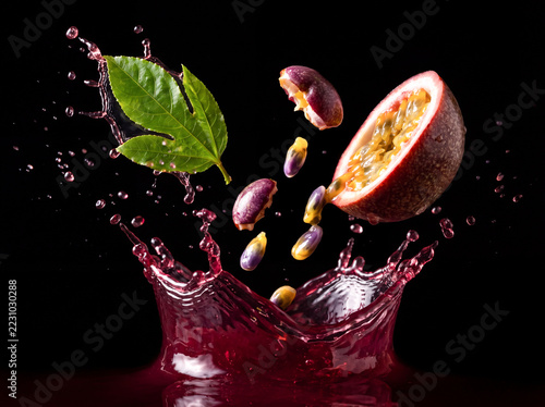 Halved Passion Fruits with Yellow Juice Splash