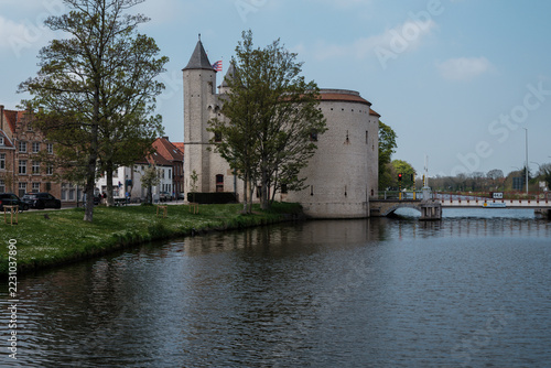 Church on the river bank in Bruges city