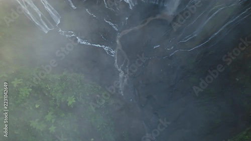 Aerial view of Panorama Tumpak Sewu Waterfalls also known as Coban Sewu.Beautiful rainbow and fog,Tumpak Sewu Waterfalls are a tourist attraction in East Java, Indonesia.Amazing travel destination