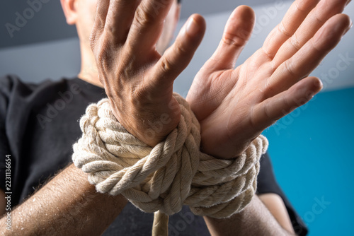 Fotografie The man's hands are tied with a rope