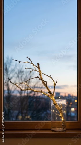 scandinavian minimalist holiday decor with fairy lights wrapped around bare branches