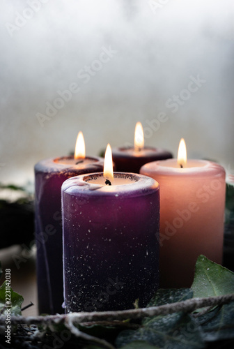 Close up of traditional Advent Christmas wreath with purple and pink candles.