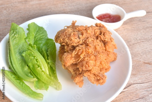 crispy fried chicken tight with fresh cos lettuce salad on plate dipping ketchup