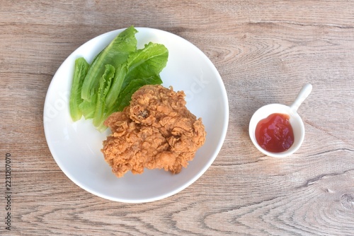 crispy fried chicken tight with fresh cos lettuce salad on plate dipping ketchup