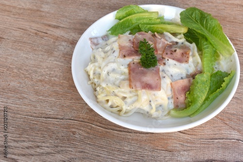 steamed spaghetti topping slice ham pork with dressing white truffle mushroom cream sauce with fresh cos lettuce salad on plate 