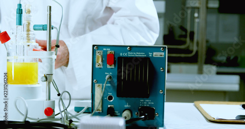 Mid section of caucasian male scientist and laboratory equipment working in laboratory, copy space