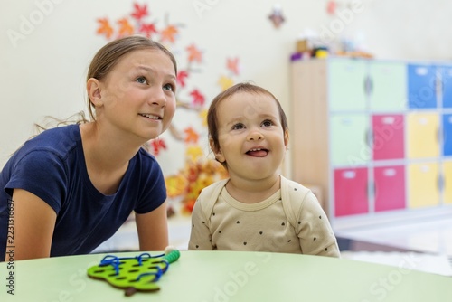 Smiling Big Sister and Toddler Looking Up with Hope, Siblings and Bright Future Concept