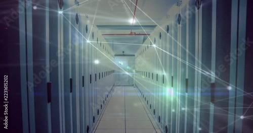 Showing rows of server cabinets stretching through climate-controlled data center, with red pipe