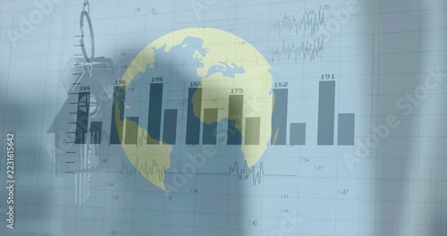 Displaying yellow-blue globe over vertical bar chart on office screen, with metal keyring and keys