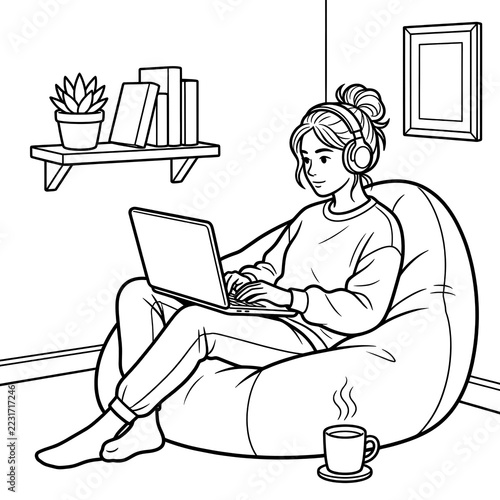 Girl working on laptop sitting in bean bag chair