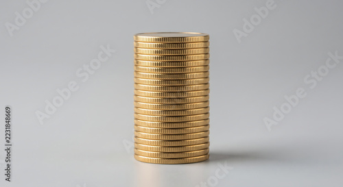 Gold Coin Stack: A tightly stacked column of gold coins, gleaming under bright lighting, symbolizes wealth and financial accumulation.