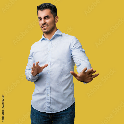 Obraz na plátně Man young casual clothes disgusted disgust face expression hand reaction aversio